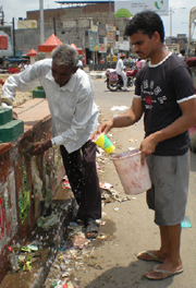 Two persons removing posters from the Fauji Chowk in Bathinda on Monday.