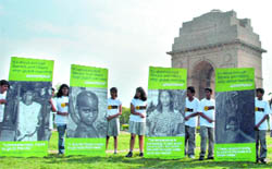 Greenpeace activists hold posters during a demonstration urging Hillary Clinton and US President Barack Obama to stop global warming at India Gate in New Delhi on Monday.