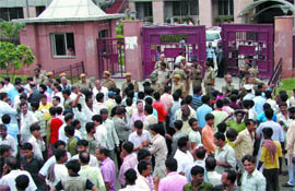 Onion and potato traders protest outside APMC office in north west Delhi on Monday.