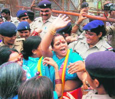 Women activists from various social and political organisations protest outside the state assembly in Dehradun on Monday.
