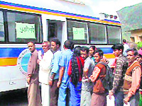 Patients in a queue outside Dr Sonens mobile clinic; and (bottom) an infant being treated inside the clinic 