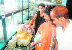 Customers check out prices at a fair price departmental store in Dehradun. 