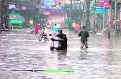 Commuters try to find their way on a waterlogged road near Mata Rani Chowk in Ludhiana on Tuesday.