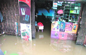 Shopkeepers of the old city area stage dharna after water entered their shops following rain on Tuesday morning.