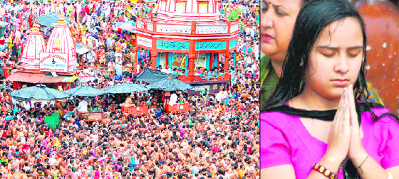 A sea of humanity at Har-Ki-Pauri in Haridwar on Wednesday on the occasion of the centurys longest solar eclipse; and (right) a young girl prays while taking a dip in the holy Ganges.