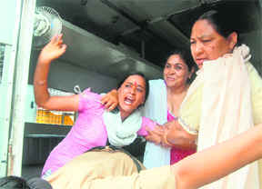 UKD activist Promila Rawat, who tried to set herself ablaze, being arrested by the police near the state assembly in Dehradun on Wednesday.