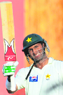 Pakistans Shoaib Malik raises his bat after scoring a century during the third and final Test match in Colombo.