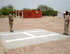 Cops stand guard near the helipad in Kaljharani village.