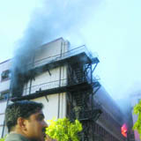 Flames and smoke billow out after a fire at CSIR building in New Delhi on Thursday.