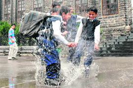 Rain provides enough scope to schoolchildren to have fun in water at Shimla on Thursday. 