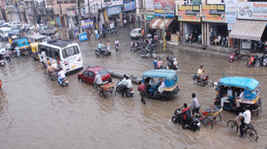 Rain Pain: Traffic moves at a snails pace on the GT Road in Jalandhar on Thursday. Schoolchildren in vans pass through waterlogged streets. 