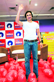 Bollywood actor and producer of Love Aaj Kal , Saif Ali Khan waves to the audience at Reliance Mart in Ahmedabad. Khan and the film's director Imtiaz Ali attended a promotional event for their new film in the city.