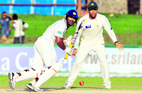 Sri Lankan captain Kumar Sangakkara plays a shot as Pakistans Khurram Manzoor looks on during the fourth day of the third and final Test match in Colombo on Thursday.