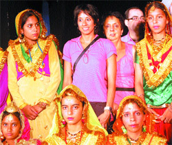 Seema Chanda Kapur and her mother pose for a picture with folk dancers in Amritsar.