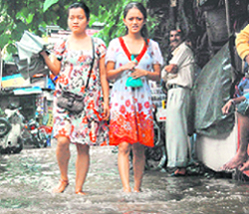 Girls wade through Indira Market area.