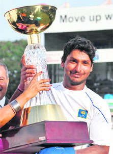 Sri Lankan captain Kumar Sangakkara with the trophy, following his teams victory in the three-match Test series against Pakistan, in Colombo on Friday.