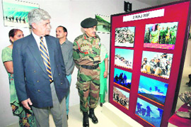 Gen VP Malik (retd) watches photos after the inauguration of the Manoj Pandey Gallery in the Drass sector of Kargil district on Saturday.