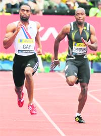 US sprinter Tyson Gay (L) competes with Great Britains Marlon Devonish to win the Mens 200m final