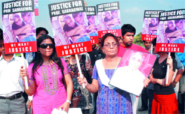 Family members of Prof Sabharwal and students protest at India Gate in New Delhi on Sunday.