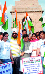 Members of BJP Minority Morcha, Delhi Pradesh, hold an awareness march and pay tributes to Kargil martyrs at India Gate, New Delhi, on Sunday, which is Kargil Vijay Divas.