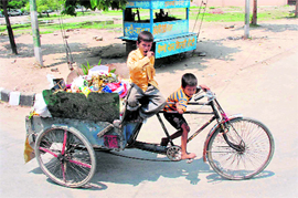 Two kids go about their job of rag picking in Karnal as usual.