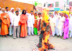 Arya Samaj activists burn an effigy of their leader, Swami Agnivesh, in protest against his support to homosexuality in Rohtak on Sunday.