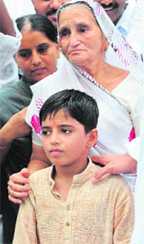Survivor of the July 2008 Ahmedabad blasts, Yash Vyas, who lost his father Dushyant and elder brother Rohan, arrives at the Civil Hospital Trauma Centre during a ceremony to mark the first anniversary of the serial blasts, in Ahmedabad on Sunday