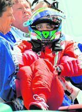 Brazilian Formula One driver Felipe Massa of Scuderia Ferrari being carried from his car after a crash on Saturday.