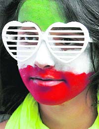 COLOURS OF PROTEST: A protester with her face painted in the colours of the Iranian national flag participates in a demonstration demanding an end to Irans clampdown on opposition activists, outside the Iranian Embassy in London