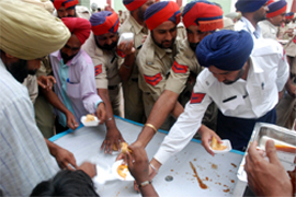 Cops reach out for refreshments at the welfare meeting in Bathinda on Monday.