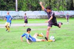 Two players vie for the ball at the District Football League in Dehradun 
