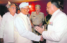 Gen S.F. Rodrigues (retd), Punjab Governor (right), greets Jagannath Pahadia after the latter was sworn in as the Haryana Governor in Chandigarh on Monday.
