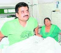 Former Deputy Chief Minister Chander Mohan talks to mediapersons in the ICU of a nursing home in Hisar on Monday while his mother Jasma Devi looks on.