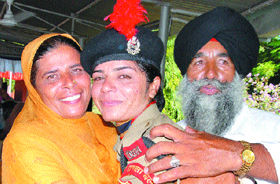 Harjot Kaur Chak Missrikhan village in Amritsar, is hugged by her parents after she was inducted into the first women contingent of the the BSF at Kharka training camp in Hoshiarpur.