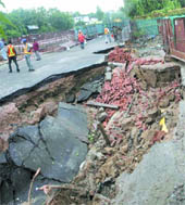 A road caved in near Hauz Khas after Monday night downpour in New Delhi on Tuesday