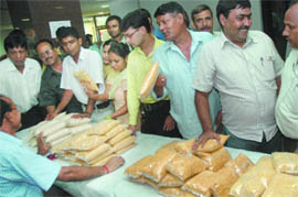 Food and civil supply officials sell pulses at Delhi Secretariat on Tuesday. 