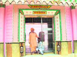 A youth seeks the blessings of the village temple priest. 