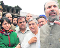 PDP leader Muzaffar Hussain Beigh (extreme right) elaborates a point during a press conference in Srinagar on Tuesday.