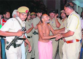 The police takes Dandi Swami to a hospital in Karnal on Tuesday night