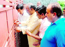 Congress workers lock the gate of DAV girls hostel in Dehradun on Thursday.