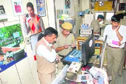 The police investigating after a theft in a shop at the Mall in Shimla.