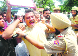 Cops prevent NC workers from storming the PDP office in Jammu on Thursday.