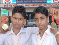 Dharmendra and Gaja Nand show their medals.