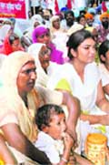 A child has meal during a dharna by farmers near Deputy Commissioners office in Amritsar 