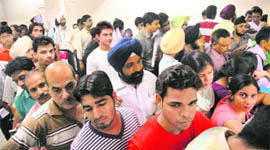 Residents wait for their turn to submit income tax returns in Chandigarh on Friday.
