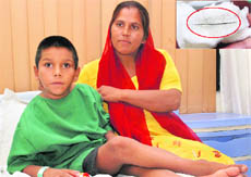 Rohit at Cosmo Hospital, Mohali, prior to a surgery and (inset) the 4-cm needle, which was removed from his back on Friday.