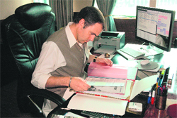 Omar Abdullah goes through a file after resuming duty as the Chief Minister 