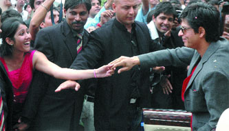 Actor Shah Rukh Khan shakes hands with an IIPM student on the institutes campus in New Delhi on Saturday.