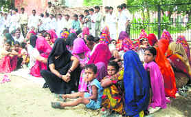 Villagers sit in dharna in support of their demand to upgrade the village school in Fatehpuria in Sirsa on Saturday. 
