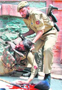 A policeman lends a helping hand to a CRPF jawan, who was critically injured in a militant attack in Srinagar